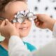 Smiling child undergoing eye test.